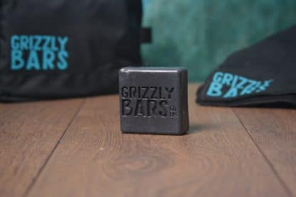 Grizzly Bars Adventure. Charcoal Lemongrass & Tea Tree soap infront of wash bag and towel